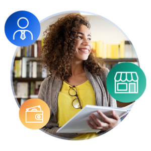 An international student smiles while holding a book in a library