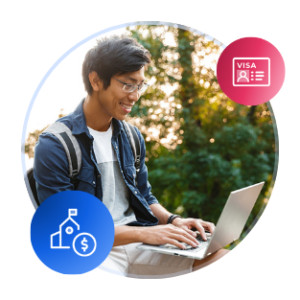 A male international student sits with an open laptop on campus at sunset or sunrise.