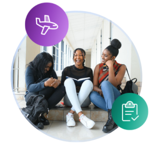 Three international students sit in a bright hallway at the top of some stairs.