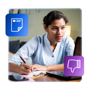 International student writing on a pad of paper while looking at a laptop